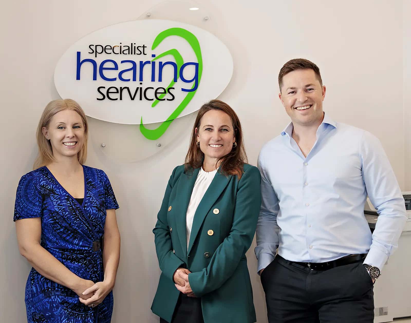 Dayle Hensman and Chris van Wijngaarden under the Specialist Hearing Services sign at the clinic.
